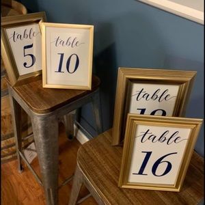 Assorted gold frames and wedding table numbers